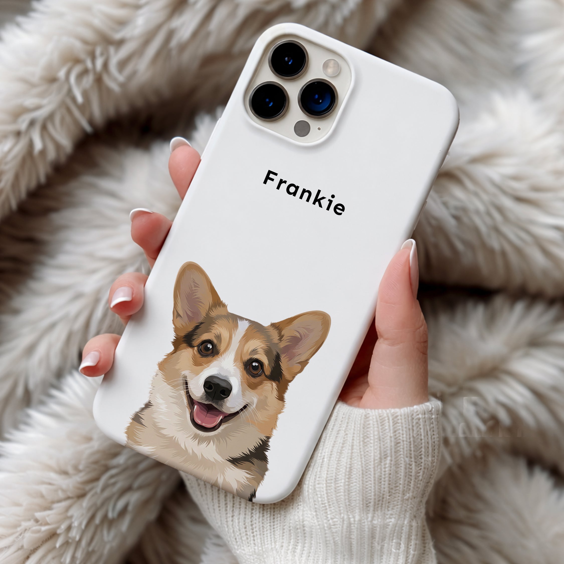 Phone case with a corgi design and 'Frankie' text, held against a fluffy beige background.